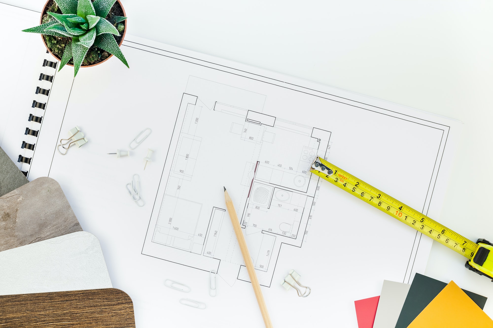 Interior designer table workplace with house plan